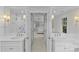 Bright bathroom with double vanity, tile shower, and doorway to bedroom at 700 Queen Charlottes Ct, Charlotte, NC 28211