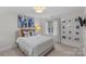 Cozy bedroom featuring neutral tones, stylish decor, and a window with natural light at 700 Queen Charlottes Ct, Charlotte, NC 28211