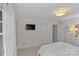 Bright bedroom with a modern light fixture, neutral paint, and a comfortable bed at 700 Queen Charlottes Ct, Charlotte, NC 28211