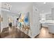 Open hallway with hardwood floors and a stylish table and decorated with lamps and decorations at 700 Queen Charlottes Ct, Charlotte, NC 28211