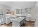 Open kitchen with white cabinets, stainless appliances, and island seating at 700 Queen Charlottes Ct, Charlotte, NC 28211