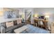 Bright living room with modern decor, desk space, and staircase at 700 Queen Charlottes Ct, Charlotte, NC 28211