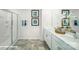 Elegant bathroom featuring dual sinks, tile flooring, a shower, and decorative mirrors at 8043 Plymouth Rd, Sherrills Ford, NC 28673