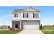 Two-story home featuring stone accents, a two-car garage, black shutters, and a well-manicured lawn at 8043 Plymouth Rd, Sherrills Ford, NC 28673