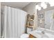 Bright bathroom featuring a stylish shower curtain, wooden storage shelves, and a modern vanity at 8211 Poplar Grove Cir # 31, Waxhaw, NC 28173