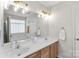 Bright bathroom with dual sinks, large mirror, soaking tub, and modern fixtures at 8211 Poplar Grove Cir # 31, Waxhaw, NC 28173