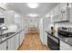 Well-lit kitchen with white cabinetry, stainless steel appliances, and eat-in dining area at 8211 Poplar Grove Cir # 31, Waxhaw, NC 28173
