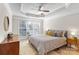 Cozy main bedroom with natural light, ceiling fan, and comfortable furnishings at 8211 Poplar Grove Cir # 31, Waxhaw, NC 28173