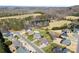 Stunning aerial view of a neighborhood featuring mature trees, a pond, and beautiful homes at 9016 Heather Trce, Gastonia, NC 28056
