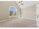 Bedroom featuring a vaulted ceiling, arch window, and carpet at 9016 Heather Trce, Gastonia, NC 28056