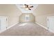 Spacious bonus room features neutral carpet, ceiling fan, and a window letting in natural light at 9016 Heather Trce, Gastonia, NC 28056