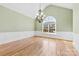 Formal dining room with hardwood floors, decorative chandelier, and large arched window at 9016 Heather Trce, Gastonia, NC 28056