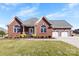 Charming brick home featuring a manicured lawn, attached two-car garage, and covered front porch at 9016 Heather Trce, Gastonia, NC 28056