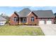 Charming brick home featuring a manicured lawn, attached two-car garage, and covered front porch at 9016 Heather Trce, Gastonia, NC 28056