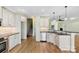 A kitchen featuring white cabinets, stainless steel appliances, and hardwood floors at 9016 Heather Trce, Gastonia, NC 28056