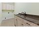 Laundry room features a sink, granite countertop, and storage cabinets at 9016 Heather Trce, Gastonia, NC 28056