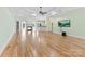 Bright living room featuring hardwood floors, fireplace, wet bar, and tray ceiling at 9016 Heather Trce, Gastonia, NC 28056