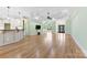 Open living room with hardwood floors, chandelier, fireplace, wet bar, and entry door at 9016 Heather Trce, Gastonia, NC 28056