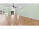 Expansive living room with hardwood floors, chandelier, fireplace, and entry door at 9016 Heather Trce, Gastonia, NC 28056