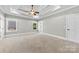 Spacious primary bedroom with tray ceiling, carpeted floors, and abundant natural light at 9016 Heather Trce, Gastonia, NC 28056