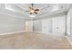 A large main bedroom with a tray ceiling, carpeted floors, and walk-in closets at 9016 Heather Trce, Gastonia, NC 28056