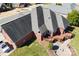 Aerial view of the back of a brick home featuring a deck, patio and well-manicured yard at 9016 Heather Trce, Gastonia, NC 28056