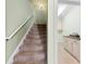 Staircase leading to the laundry room with carpeted steps at 9016 Heather Trce, Gastonia, NC 28056