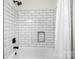 Modern bathroom featuring tiled shower and bathtub with matte black fixtures at 10211 Ridgewell Ct, Charlotte, NC 28215