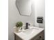 Stylish powder room featuring a modern vanity, decorative mirror, and neutral color palette at 10211 Ridgewell Ct, Charlotte, NC 28215