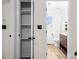 Bathroom with an open shelved closet and a vanity with marble countertop and wood drawers at 10211 Ridgewell Ct, Charlotte, NC 28215