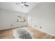 A bedroom with light-colored wood flooring, a ceiling fan and a door to an exterior view at 10211 Ridgewell Ct, Charlotte, NC 28215