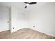 A bedroom with light-colored wood flooring, a ceiling fan and a closet with bi-fold doors at 10211 Ridgewell Ct, Charlotte, NC 28215