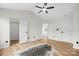 A bedroom with light-colored wood flooring, a ceiling fan and a walk in closet at 10211 Ridgewell Ct, Charlotte, NC 28215