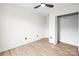 A bedroom with light-colored wood flooring, a ceiling fan and a closet at 10211 Ridgewell Ct, Charlotte, NC 28215