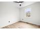 Bright bedroom featuring a ceiling fan, hardwood floors, and a window providing natural light at 10211 Ridgewell Ct, Charlotte, NC 28215