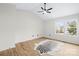 A bedroom with light-colored wood flooring, a ceiling fan and a large window at 10211 Ridgewell Ct, Charlotte, NC 28215