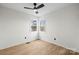 Bright bedroom featuring two windows that provides natural light and hardwood floors at 10211 Ridgewell Ct, Charlotte, NC 28215