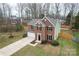 Aerial view of a two-story brick home with a well-manicured lawn, attached garage and a black front door at 10211 Ridgewell Ct, Charlotte, NC 28215