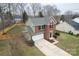 Aerial view of a two-story brick home with a well-manicured lawn, attached garage and a black front door at 10211 Ridgewell Ct, Charlotte, NC 28215
