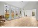 Sun-filled living room boasting large windows, wood-look floors, and a comfortable chair at 10211 Ridgewell Ct, Charlotte, NC 28215