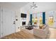 Bright living room features a fireplace, large windows, and vaulted ceilings at 10211 Ridgewell Ct, Charlotte, NC 28215