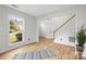 Bright and airy living room featuring wood floors, white trim, and a large window at 10211 Ridgewell Ct, Charlotte, NC 28215