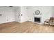 Living room features a fireplace, a comfortable chair, and wood-look floors at 10211 Ridgewell Ct, Charlotte, NC 28215