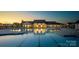 Swimming pool and clubhouse with lights reflecting in the water during a gorgeous sunset at 1035 Bourn Ln, Waxhaw, NC 28173