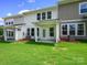 Grassy backyard with a covered patio, ideal for outdoor entertaining and relaxation at 113 Alluvium Ln, Waxhaw, NC 28173