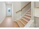 Bright entryway with light wood floors, white walls, and a staircase leading to the upper level of the house at 113 Alluvium Ln, Waxhaw, NC 28173
