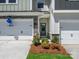 Inviting front entrance with stone accents, double garage, and a well-maintained landscape at 113 Alluvium Ln, Waxhaw, NC 28173