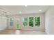 Spacious living room with large windows, natural light, and a view of the backyard at 113 Alluvium Ln, Waxhaw, NC 28173