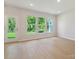Inviting living room with bright windows offering tranquil green views and a door to the outside at 113 Alluvium Ln, Waxhaw, NC 28173