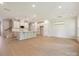 Open floor plan reveals the kitchen, living, and dining areas, with hardwood floors and recessed lighting at 113 Alluvium Ln, Waxhaw, NC 28173